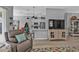 Comfortable living area with a TV, a breakfast bar, and a partial view of the kitchen at 2892 Myakka Creek Ct, Port Charlotte, FL 33953