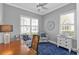 Bright home office with plantation shutters, ceiling fan and neutral paint on the walls and a blue rug on the floor at 2892 Myakka Creek Ct, Port Charlotte, FL 33953