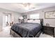 Bedroom features a bed with dark bedding, overhead fan, and natural light from a window at 3510 Amanda St, Punta Gorda, FL 33950