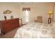 Cozy bedroom with a large dresser and a comfortable chair near a sunny window at 379 Bal Harbor Blvd, Punta Gorda, FL 33950