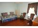 Comfortable bedroom with hardwood floors, daybed, and well-lit from the window at 379 Bal Harbor Blvd, Punta Gorda, FL 33950