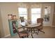 Cozy breakfast nook with a round table, comfortable chairs, and natural light from the windows at 379 Bal Harbor Blvd, Punta Gorda, FL 33950
