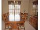 Formal dining room features a large wooden table, and is complemented by natural light from the window at 379 Bal Harbor Blvd, Punta Gorda, FL 33950