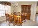 Traditional dining room with wooden furniture, tile floors, and a large window that provides ample natural light at 379 Bal Harbor Blvd, Punta Gorda, FL 33950