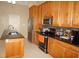 Remodeled kitchen features stainless steel appliances, granite countertops, and warm wood cabinets at 379 Bal Harbor Blvd, Punta Gorda, FL 33950