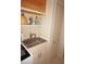 Practical laundry area with a utility sink and storage shelves for cleaning supplies at 379 Bal Harbor Blvd, Punta Gorda, FL 33950