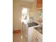 Functional laundry room featuring a washer, dryer, and sink, maximizing convenience at 379 Bal Harbor Blvd, Punta Gorda, FL 33950