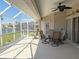 Enjoy outdoor dining on this screened lanai with waterfront views and a ceiling fan at 379 Bal Harbor Blvd, Punta Gorda, FL 33950