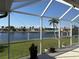 A screened-in lanai offers scenic water views of lush landscaping and waterfront homes at 379 Bal Harbor Blvd, Punta Gorda, FL 33950