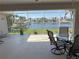 Enclosed patio overlooking a canal with waterway access, including a table and chairs at 379 Bal Harbor Blvd, Punta Gorda, FL 33950