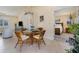 Cozy dining area with a glass table, wicker chairs, and views to the bedroom and living area at 4114 Kinney St, Port Charlotte, FL 33948