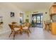 Bright dining area with a glass table, tile flooring, and sliding glass doors to outdoor space at 4114 Kinney St, Port Charlotte, FL 33948