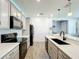 A modern kitchen with stainless steel appliances, quartz countertops, and sleek cabinetry at 8858 Tuscany Isles Dr, Punta Gorda, FL 33950