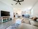 Spacious living room with comfortable seating, TV and decorative accents that flows to dining at 8858 Tuscany Isles Dr, Punta Gorda, FL 33950