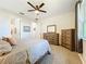 A bright main bedroom with carpet, ceiling fan, walk-in closets and ensuite bathroom at 8858 Tuscany Isles Dr, Punta Gorda, FL 33950