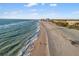 Aerial view of pristine beach and clear blue waters with coastal property at 908 Golden Beach Blvd # 201, Venice, FL 34285