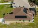 Aerial view of a home with solar panels and screened-in pool, highlighting modern amenities at 1210 Nabatoff St, North Port, FL 34288