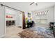 Bright home office featuring a ceiling fan, large window, desk setup, and stylish rug at 1210 Nabatoff St, North Port, FL 34288