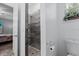 Bathroom showcases tiled walk-in shower with pebble floor and a view into the bedroom at 122 Glades Dr, Rotonda West, FL 33947
