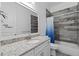 Bathroom featuring a large mirror, tiled walls, granite countertop and large vanity at 122 Glades Dr, Rotonda West, FL 33947