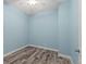 The bedroom features light blue walls and tile floors at 122 Glades Dr, Rotonda West, FL 33947