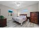 Comfortable bedroom featuring a ceiling fan, warm colors, and wood-look tile floors at 122 Glades Dr, Rotonda West, FL 33947