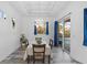 Dining room features tile floors, bright lighting, and a sliding glass door to the outdoor space at 122 Glades Dr, Rotonda West, FL 33947