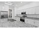 Kitchen features stainless steel appliances, granite countertops, white cabinets, and an island with a sink at 122 Glades Dr, Rotonda West, FL 33947