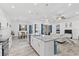 Bright and open kitchen with stainless steel appliances, a spacious island, and a view into the living room at 122 Glades Dr, Rotonda West, FL 33947