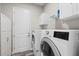 Laundry room showcasing modern washer and dryer set, and storage cabinets at 122 Glades Dr, Rotonda West, FL 33947