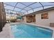 Sparkling pool with screened enclosure, outdoor seating, and covered lanai at 122 Glades Dr, Rotonda West, FL 33947