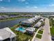 Aerial view featuring a community pool, lake, townhomes and surrounding landscaping at 14204 Heritage Landing Blvd # 724, Punta Gorda, FL 33955