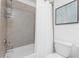 Tiled shower and tub combination with a white toilet and framed wall art at 14204 Heritage Landing Blvd # 724, Punta Gorda, FL 33955