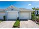 Charming home exterior with a two-car garage and a well-maintained lawn at 14204 Heritage Landing Blvd # 724, Punta Gorda, FL 33955