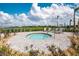 The outdoor hot tub is surrounded by lounge chairs and landscaping, with a lake view at 14204 Heritage Landing Blvd # 724, Punta Gorda, FL 33955