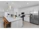 Bright, modern kitchen featuring quartz countertops, stainless steel appliances, and bar stool seating, ideal for entertaining at 14204 Heritage Landing Blvd # 724, Punta Gorda, FL 33955