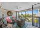 Relaxing screened patio with comfortable wicker furniture, string lights, and a view of palm trees at 14204 Heritage Landing Blvd # 724, Punta Gorda, FL 33955