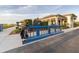 Exterior detail of the clubhouse with golf bag rack, golf clubs, and lush landscaping at 14652 Cherry Blossom Way, Punta Gorda, FL 33955