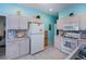 Kitchen featuring white cabinets, tile backsplash, and plenty of counter space at 1498 Red Oak Ln, Port Charlotte, FL 33948