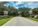 Scenic street view with lush trees leading to a welcoming neighborhood at 1498 Red Oak Ln, Port Charlotte, FL 33948