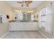 Bright bathroom with double sinks, a large mirror, and a window providing natural light at 15090 Buswell Ave, Port Charlotte, FL 33953