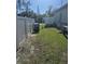 A well-maintained side yard is enclosed with a white vinyl fence at 1594 Hempstead Ave, North Port, FL 34286