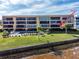 View of condo Unit 112, and the building's outdoor pool and waterfront access at 1601 Park Beach Cir # 112/2, Punta Gorda, FL 33950