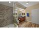 Bathroom featuring double sinks, granite countertop, wood-style floors and a tiled walk-in shower at 17495 Boca Vista Rd # 6, Punta Gorda, FL 33955