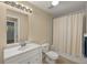 Well-lit bathroom featuring a shower/tub combo and a white vanity with ample counter space at 17495 Boca Vista Rd # 6, Punta Gorda, FL 33955