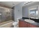 Bathroom showcasing a glass enclosed shower, granite counters, and a large mirror above the vanity at 17495 Boca Vista Rd # 6, Punta Gorda, FL 33955