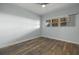 Bedroom offering wood-look floors, neutral walls, and a window providing natural light at 17495 Boca Vista Rd # 6, Punta Gorda, FL 33955