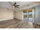 Spacious bedroom featuring wood laminate flooring and a sliding glass door to a balcony at 17495 Boca Vista Rd # 6, Punta Gorda, FL 33955