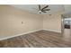 Spacious bedroom featuring a ceiling fan and light-colored walls with wood laminate flooring at 17495 Boca Vista Rd # 6, Punta Gorda, FL 33955