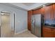 Kitchen area with stainless steel refrigerator, and matching oven and microwave, with dark countertops at 17495 Boca Vista Rd # 6, Punta Gorda, FL 33955